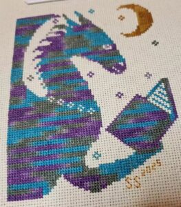 dragon reading cross stitch